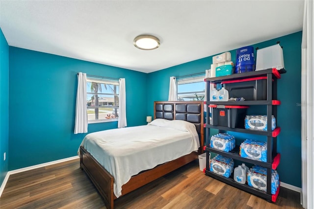 1021 Augusta Dr, Sun City Center, FL 33573 - bedroom featuring multiple windows, baseboards, and wood finished floors