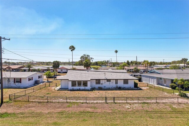 1021 Augusta Dr, Sun City Center, FL 33573 - view of front facade featuring a residential view, fence private yard, and a front yard