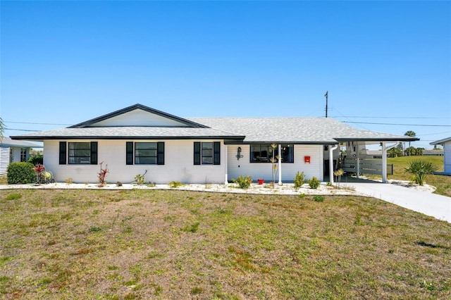 1021 Augusta Dr, Sun City Center, FL 33573 - ranch-style house featuring a carport, driveway, a front yard, and roof with shingles