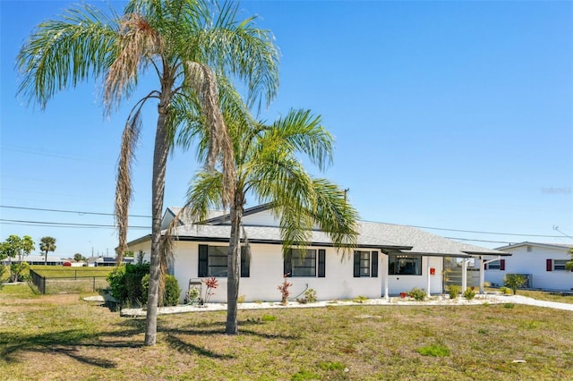 1021 Augusta Dr, Sun City Center, FL 33573 - ranch-style house featuring a front yard and fence