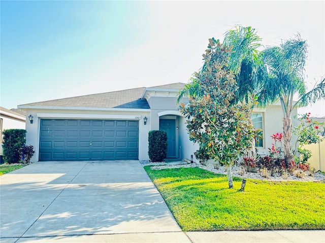 ranch-style house featuring stucco siding, driveway, an attached garage, and a front yard