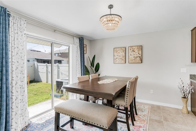 10105 Paradise Fish Dr, Riverview, FL 33578 - dining space featuring an inviting chandelier, light tile patterned floors, and baseboards
