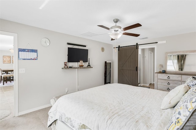 10105 Paradise Fish Dr, Riverview, FL 33578 - bedroom with visible vents, ceiling fan, baseboards, a barn door, and light carpet