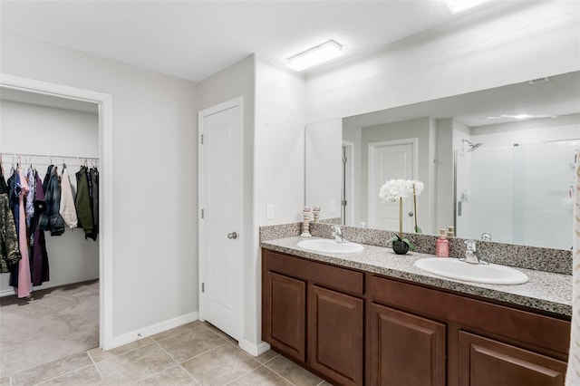 10105 Paradise Fish Dr, Riverview, FL 33578 - bathroom with a walk in closet, a shower stall, double vanity, and a sink