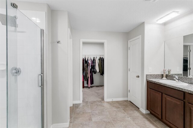 10105 Paradise Fish Dr, Riverview, FL 33578 - full bathroom featuring baseboards, vanity, a spacious closet, and a shower stall