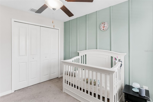 10105 Paradise Fish Dr, Riverview, FL 33578 - bedroom featuring visible vents, carpet floors, a crib, a closet, and a decorative wall