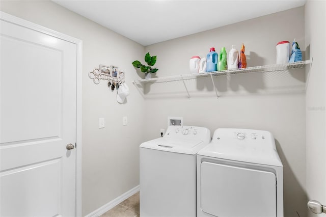 10105 Paradise Fish Dr, Riverview, FL 33578 - washroom featuring washer and dryer, laundry area, light tile patterned flooring, and baseboards