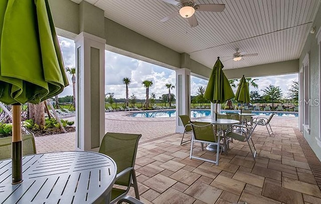 10105 Paradise Fish Dr, Riverview, FL 33578 - view of patio / terrace featuring outdoor dining space, ceiling fan, and a community pool