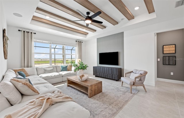 living room with visible vents, beamed ceiling, baseboards, and ceiling fan