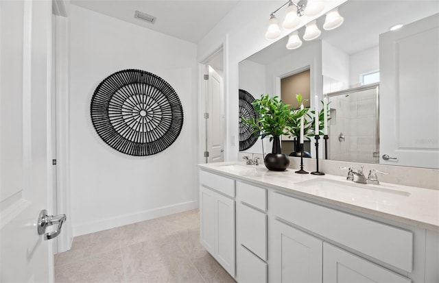 full bathroom featuring a sink, visible vents, double vanity, and a shower stall