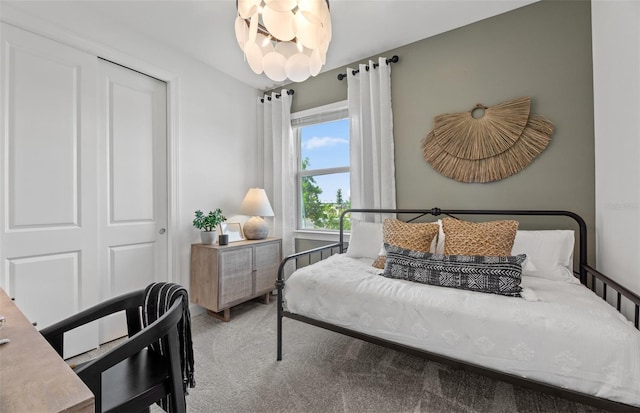 bedroom featuring a closet, a chandelier, and carpet flooring