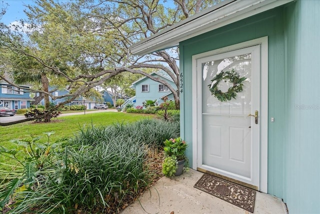 property entrance with a yard