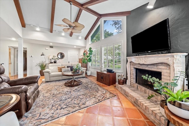 tiled living room with beam ceiling, a fireplace, high vaulted ceiling, and a ceiling fan