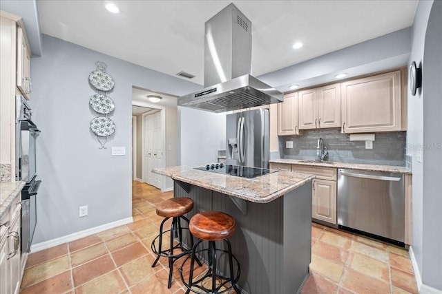 kitchen featuring a breakfast bar area, decorative backsplash, island exhaust hood, black appliances, and a sink