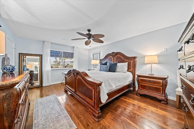 bedroom with baseboards, wood-type flooring, and ceiling fan