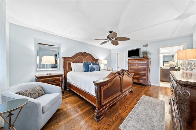 bedroom with hardwood / wood-style flooring, visible vents, and ceiling fan