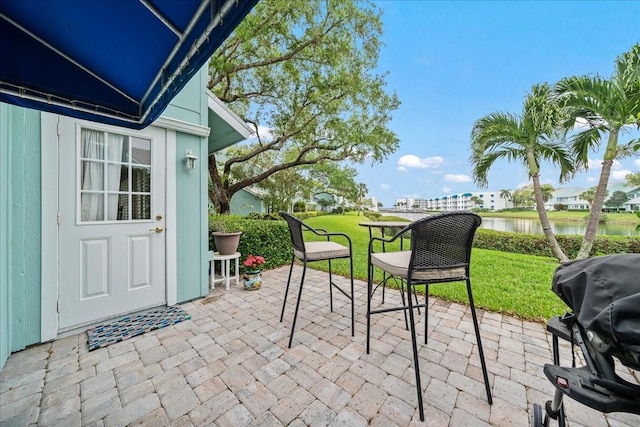 view of patio featuring grilling area and a water view