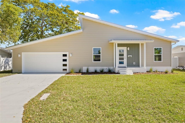 mid-century home featuring an attached garage, concrete driveway, and a front yard