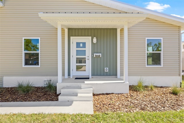 view of exterior entry with board and batten siding