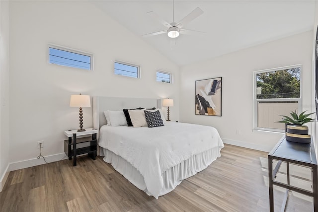 bedroom featuring lofted ceiling, wood finished floors, baseboards, and ceiling fan