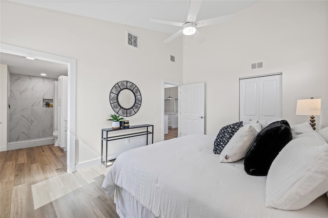 bedroom with light wood-style floors, visible vents, a closet, and baseboards