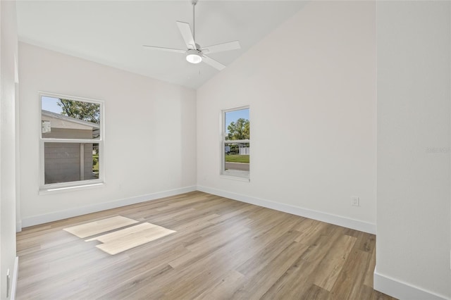 spare room with a healthy amount of sunlight, baseboards, and wood finished floors