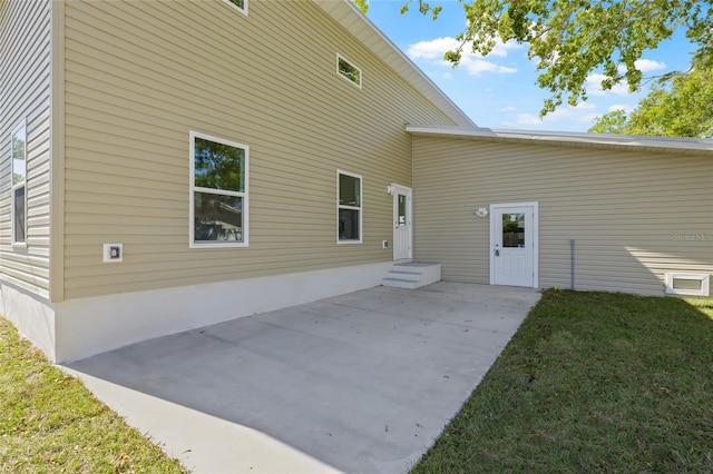 back of property with a patio and a lawn