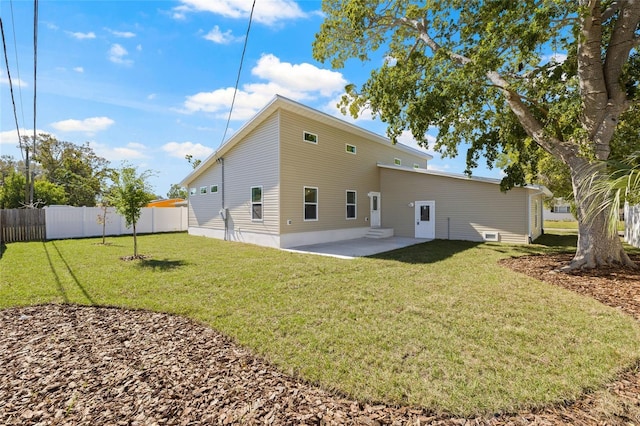 back of property featuring a patio area, fence, and a lawn