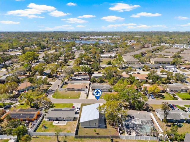 drone / aerial view featuring a residential view and a water view