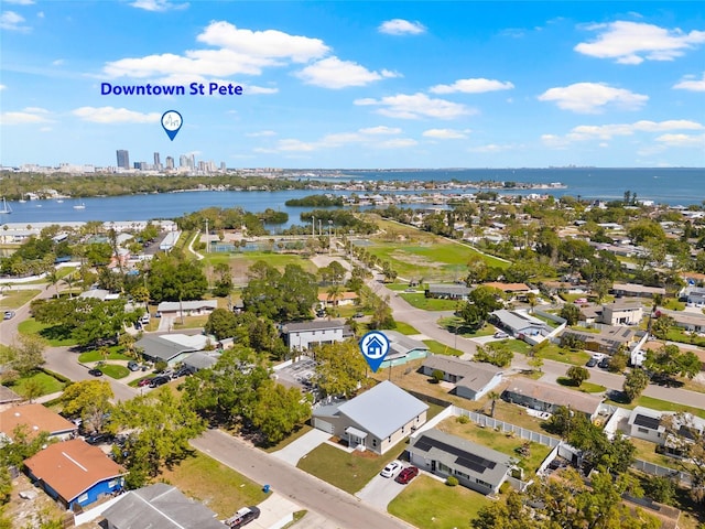 birds eye view of property featuring a city view and a water view