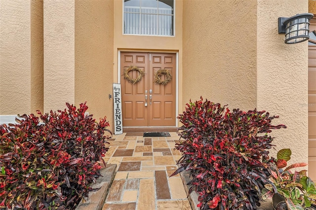 property entrance with stucco siding