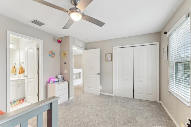 bedroom with visible vents, ceiling fan, baseboards, light carpet, and a closet