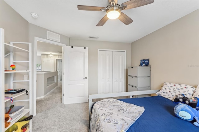 bedroom with a ceiling fan, carpet, visible vents, and a closet