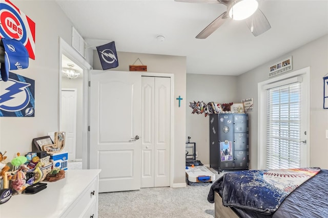 bedroom featuring visible vents, a ceiling fan, a closet, and light carpet