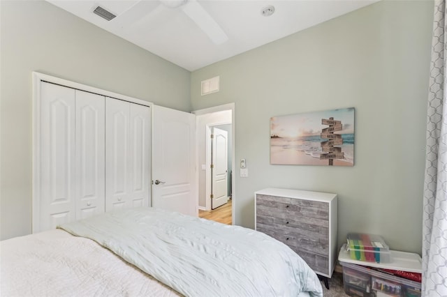 bedroom featuring a closet, visible vents, and ceiling fan