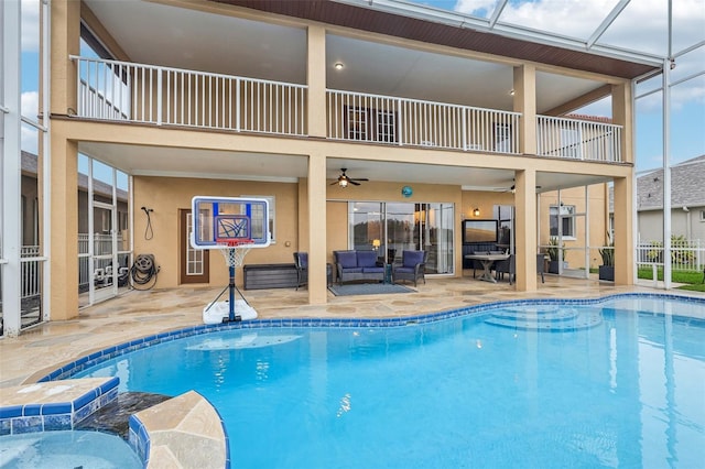 view of pool with a ceiling fan, a lanai, a patio area, and a pool with connected hot tub