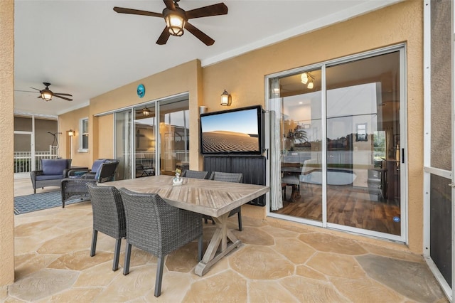 sunroom / solarium with a ceiling fan