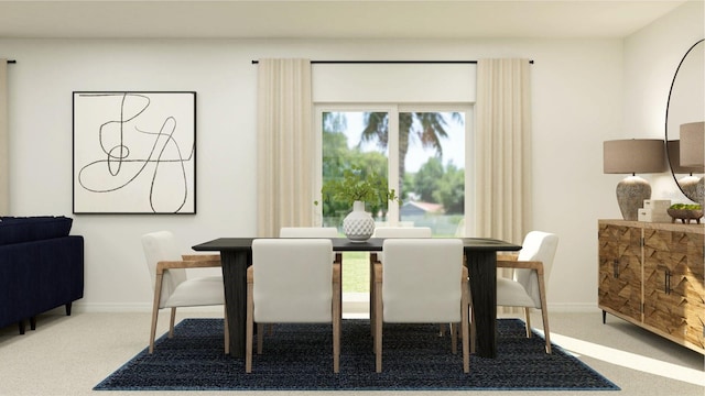 carpeted dining room with baseboards