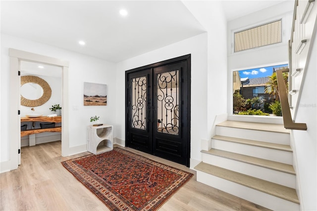 517 Belle Isle Ave, Belleair Beach, FL 33786 - foyer entrance featuring recessed lighting, baseboards, stairway, and wood finished floors