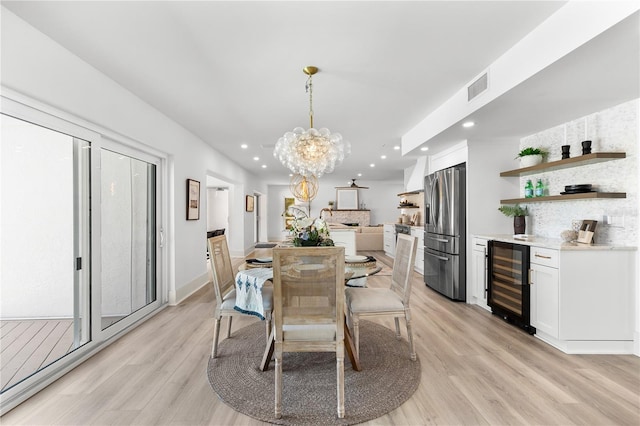 517 Belle Isle Ave, Belleair Beach, FL 33786 - dining space featuring a chandelier, beverage cooler, light wood-style flooring, visible vents, and recessed lighting