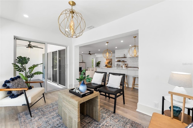517 Belle Isle Ave, Belleair Beach, FL 33786 - living room with visible vents, light wood-type flooring, recessed lighting, and ceiling fan with notable chandelier