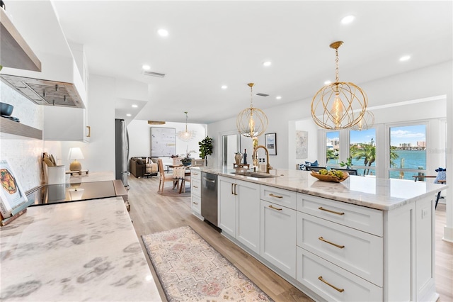 517 Belle Isle Ave, Belleair Beach, FL 33786 - kitchen with an inviting chandelier, a sink, appliances with stainless steel finishes, and wall chimney exhaust hood