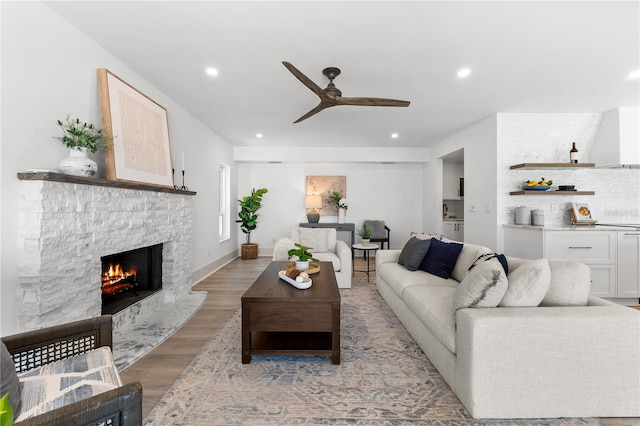 517 Belle Isle Ave, Belleair Beach, FL 33786 - living area with a fireplace, light wood-style flooring, baseboards, ceiling fan, and recessed lighting