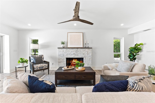 517 Belle Isle Ave, Belleair Beach, FL 33786 - living room featuring recessed lighting, baseboards, ceiling fan, a fireplace, and wood finished floors