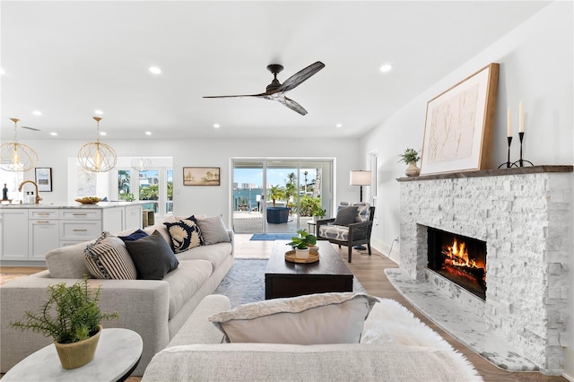 517 Belle Isle Ave, Belleair Beach, FL 33786 - living area with light wood finished floors, baseboards, a fireplace, ceiling fan, and recessed lighting