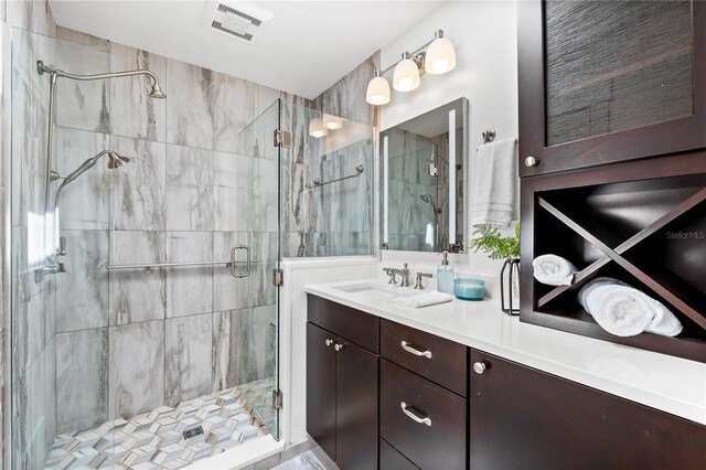 517 Belle Isle Ave, Belleair Beach, FL 33786 - bathroom featuring a shower stall, visible vents, and vanity