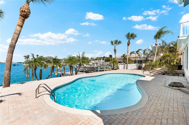 517 Belle Isle Ave, Belleair Beach, FL 33786 - outdoor pool with fence, boat lift, a dock, a water view, and a patio area