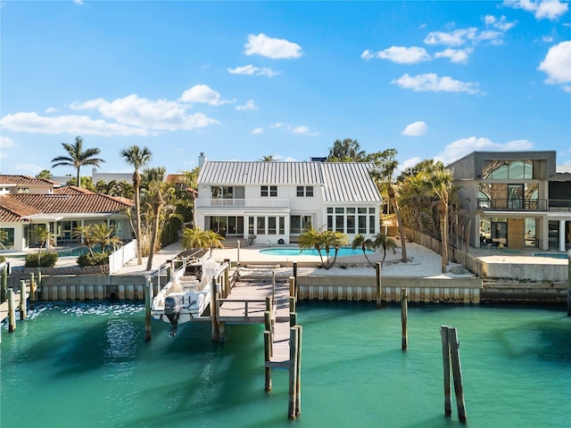 517 Belle Isle Ave, Belleair Beach, FL 33786 - dock area featuring a water view, a balcony, boat lift, and an outdoor pool