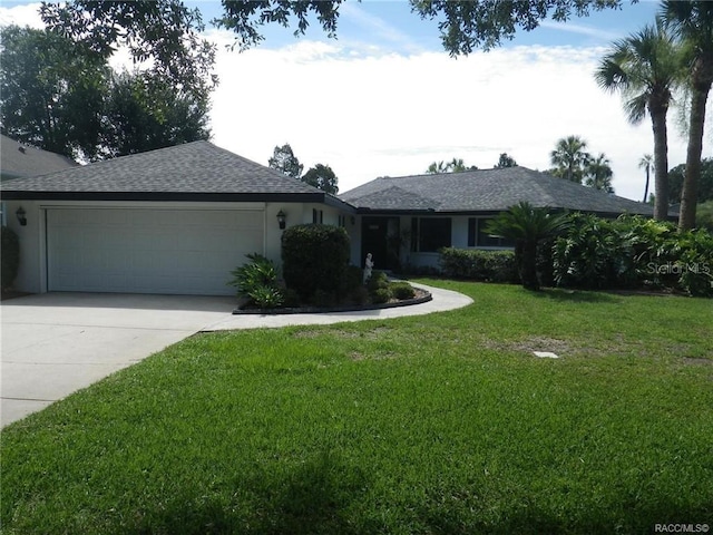 ranch-style home with stucco siding, a front lawn, concrete driveway, an attached garage, and a shingled roof