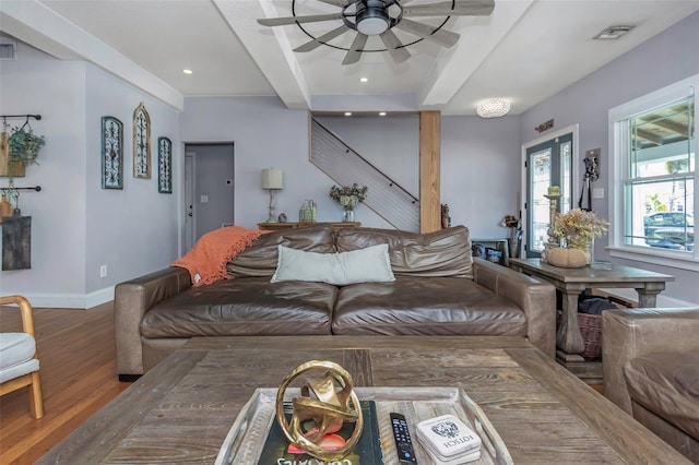 living room with beamed ceiling, visible vents, a ceiling fan, wood finished floors, and baseboards